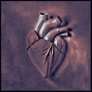 a leather heart piece of art on a table